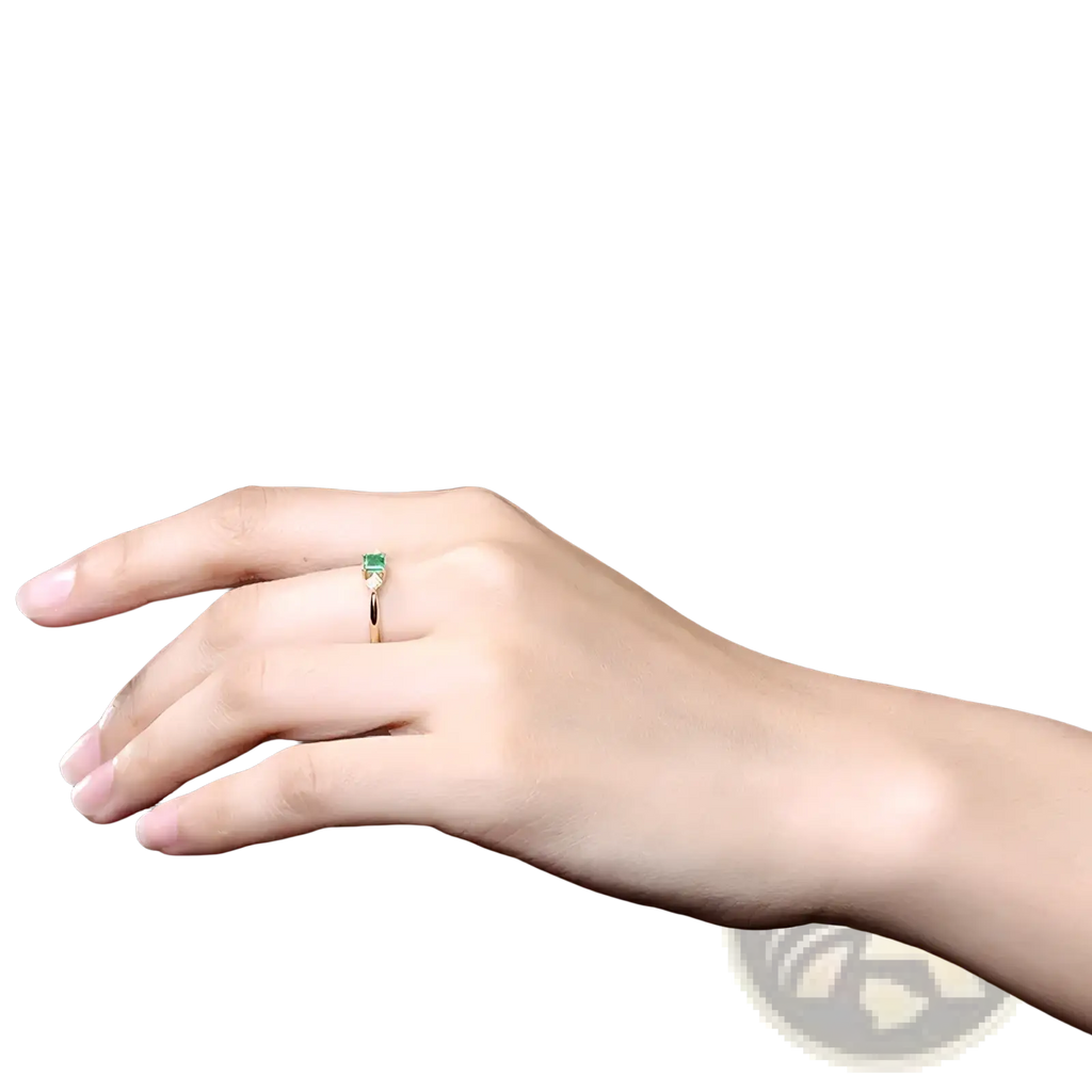 18k gold emerald diamond engagement ring with a delicate gold band and a rectangular emerald stone in a minimalist design