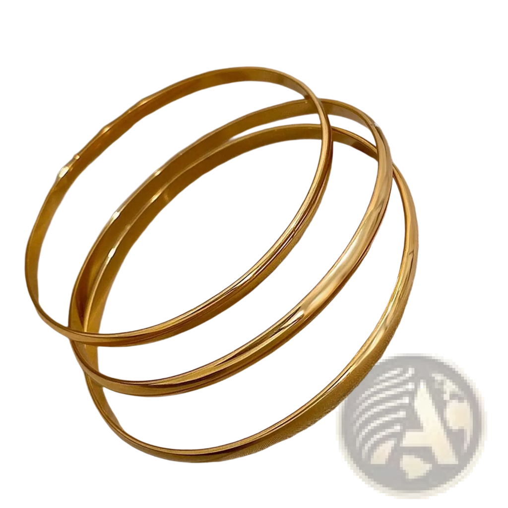 Three sleek gold toned 18k gold plated minimalist stackable bangles with a polished metallic finish