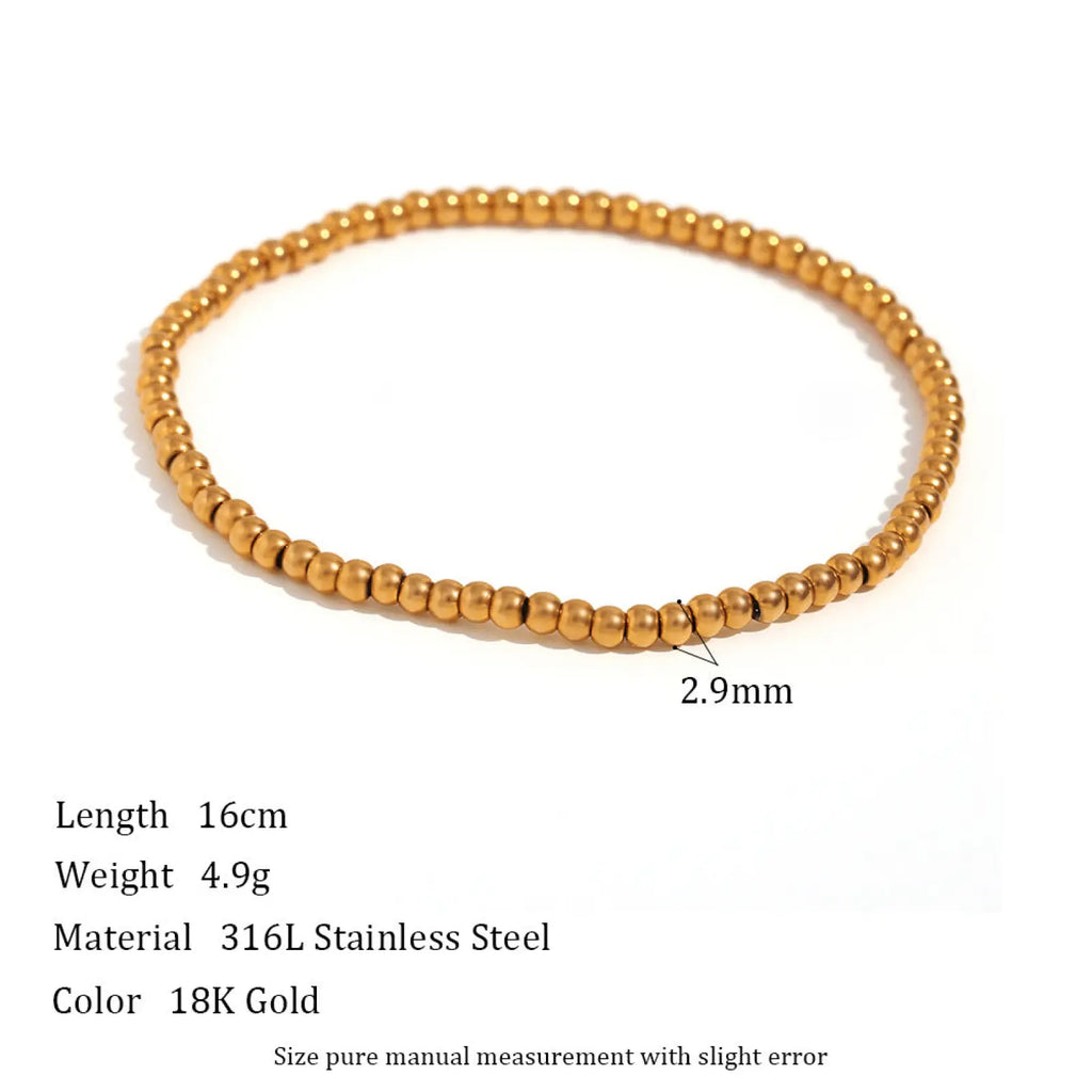 A delicate 16cm 18k gold plated stainless steel stretch bracelet with elastic beads and polished finish