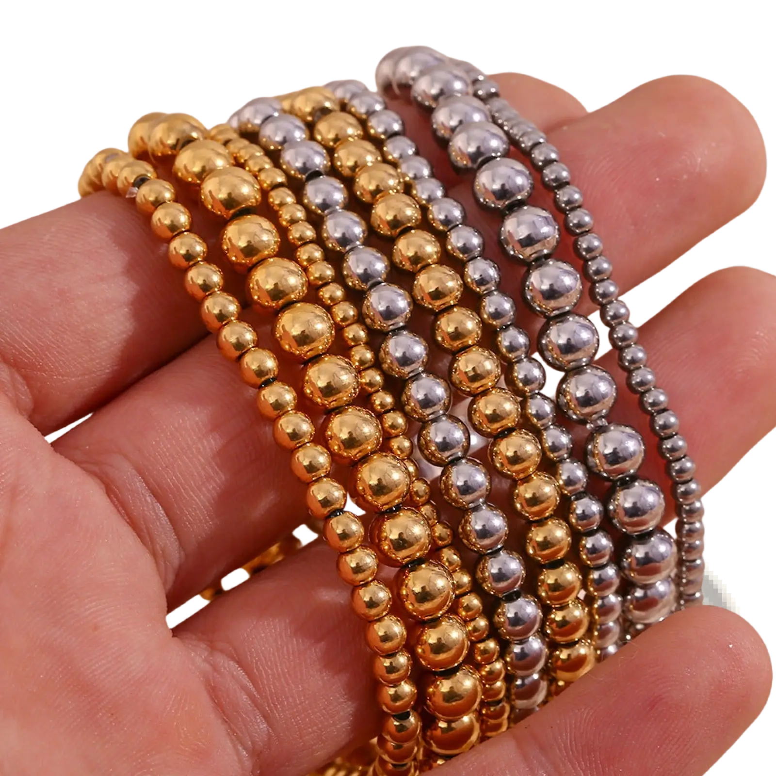 A hand holds 18k gold plated stainless steel elastic bead bracelets with alternating gold and silver polished beads