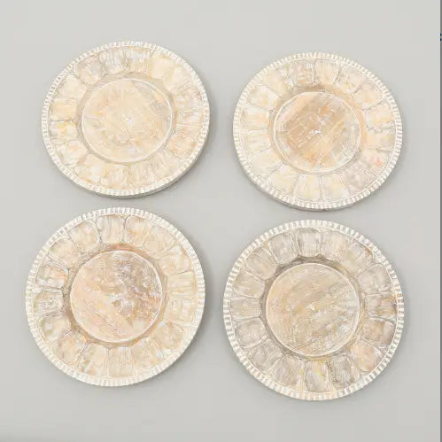 Lot de quatre dessous-de-plat circulaires en os blanc vieilli avec incrustation, bord festonné, provenant de l’ensemble de table rustique en assiettes plates en bois.