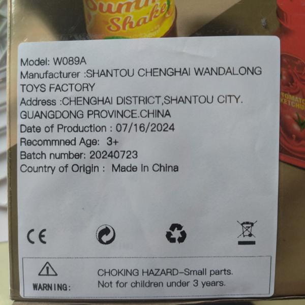 White label with black text on the back side detailing product information for a smoking barbecue grill toy with light and sound features.