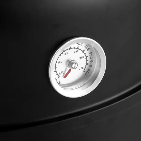 Tragbarer Grill aus Eisen für Holzkohle-Räucherraucher mit einem silbernen, kreisförmigen Thermometer mit rotem Zeiger und schwarzen Markierungen, montiert auf einer dunklen Oberfläche.