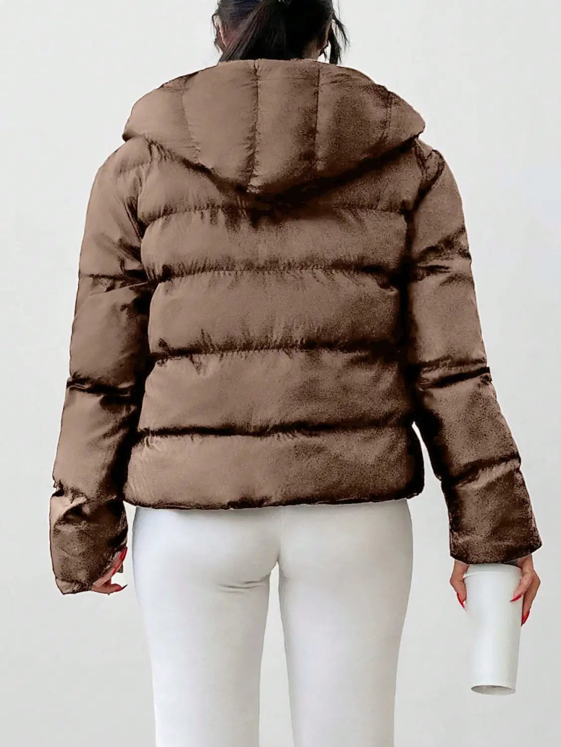 A brown quilted puffer jacket for women with a hood and long sleeves designed for warmth and comfort.