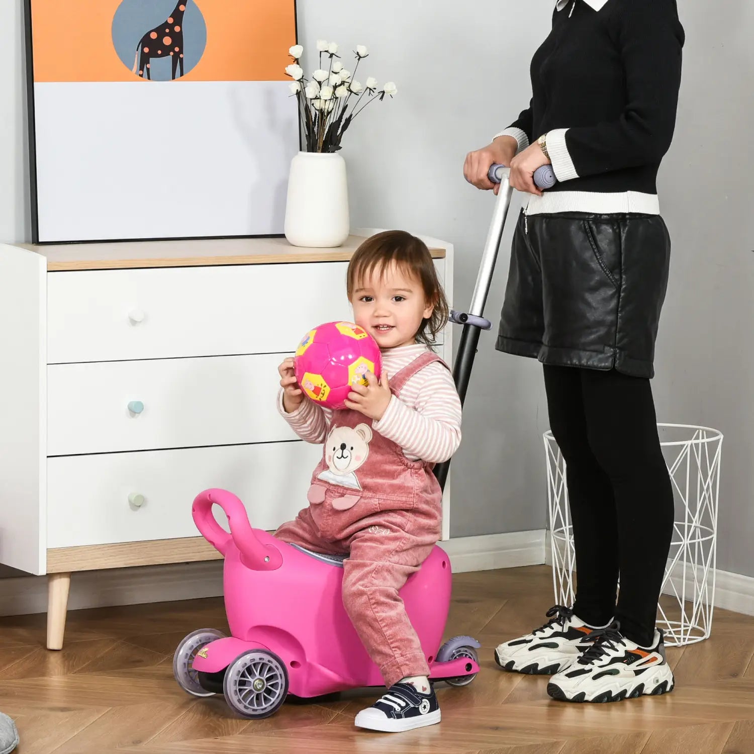 Pink plastic toddler ride-on toy with handle and wheels designed as a 3-in-1 kids scooter ride on push walker for ages 2 to 6 years.