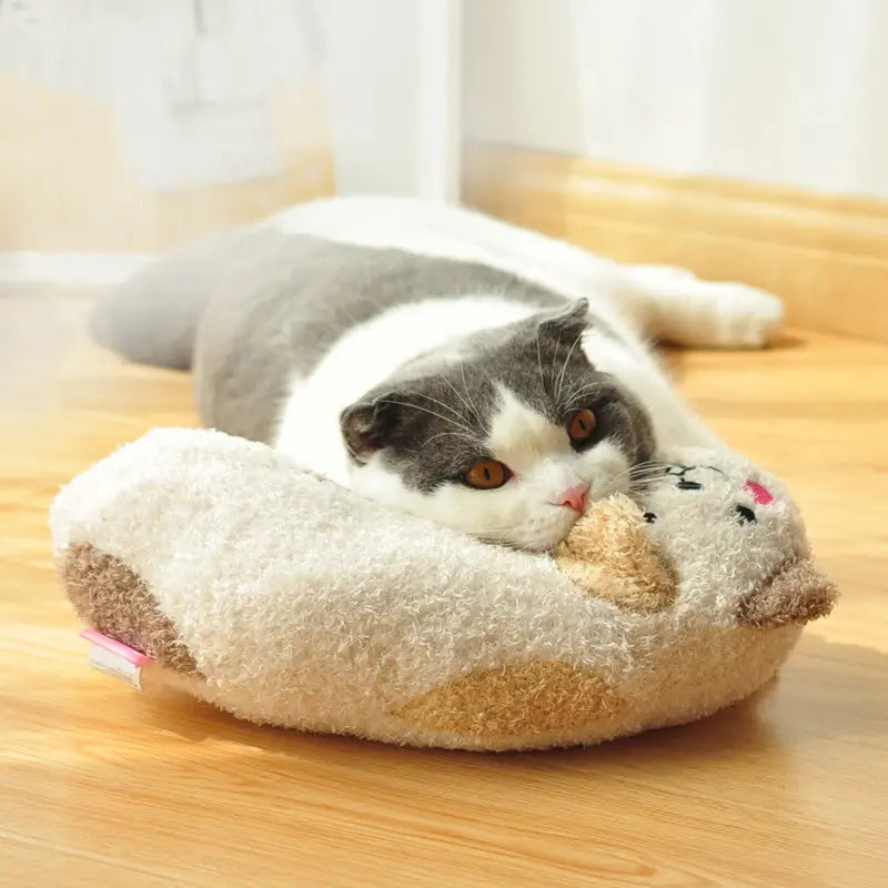 Ein plüschiges, cremefarbenes Katzenkissen aus weichem, strukturiertem Stoff mit einem niedlichen Cartoon-Gesichtsdesign zur Nackenunterstützung und Gelenkentlastung.