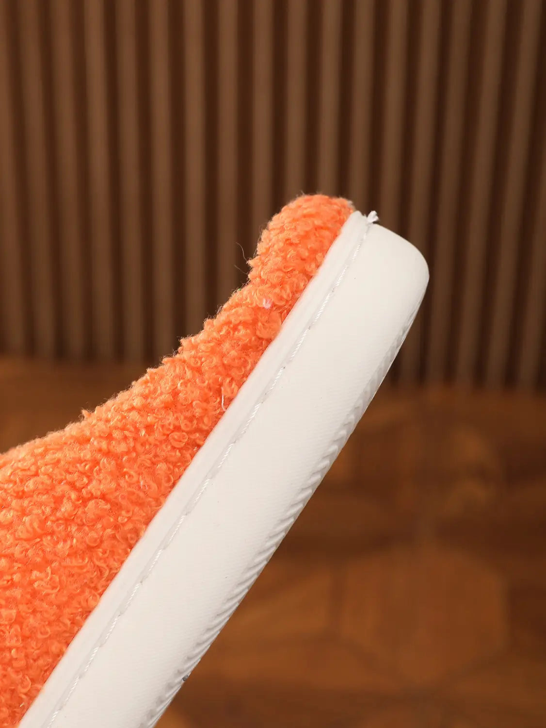 Orange plush floral cotton slipper with soft white TPR rubber sole displayed from the back side.