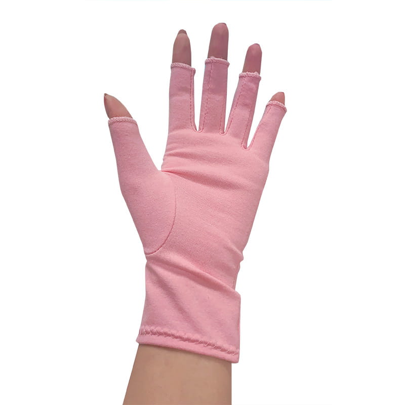A soft pink arthritis compression glove fingerless support made of smooth fabric with neatly stitched edges.