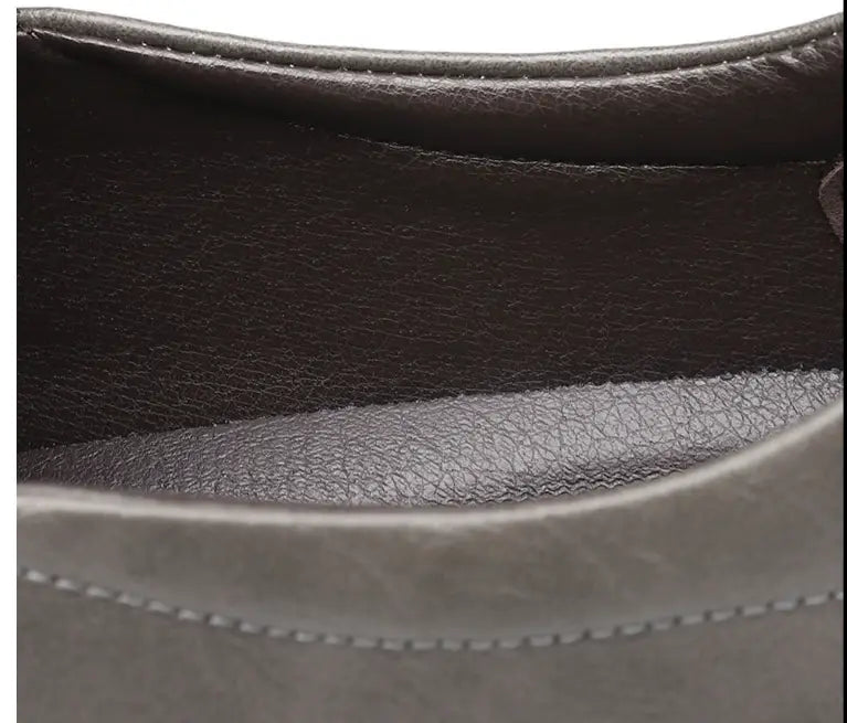 Men’s breathable non slip gray leather slip-on loafers with textured sole and visible stitching.