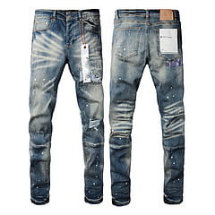 Men’s distressed slim fit patchwork denim jeans in blue with a faded wash and intentional rips featuring a classic five-pocket design.