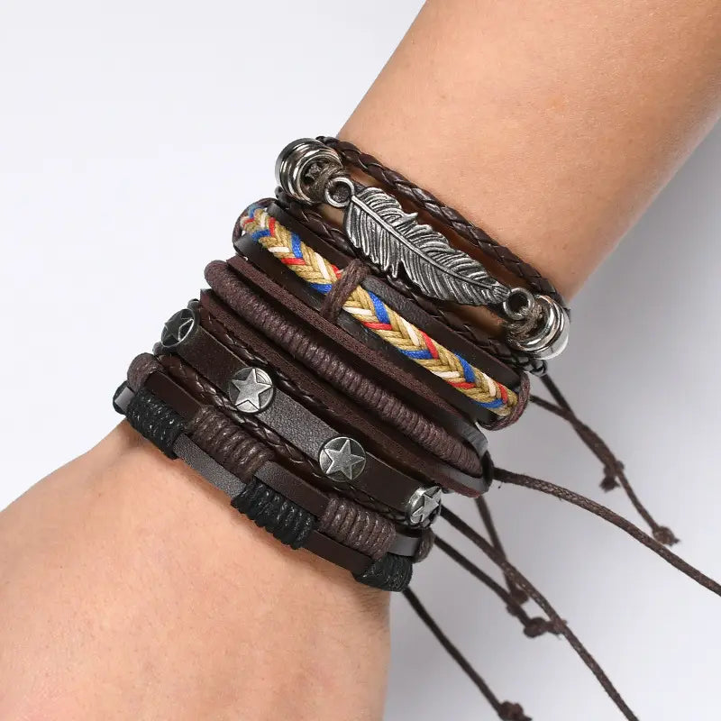 Men’s multilayer leather bracelet featuring stacked brown leather and braided cord with silver star studs and a feather charm.