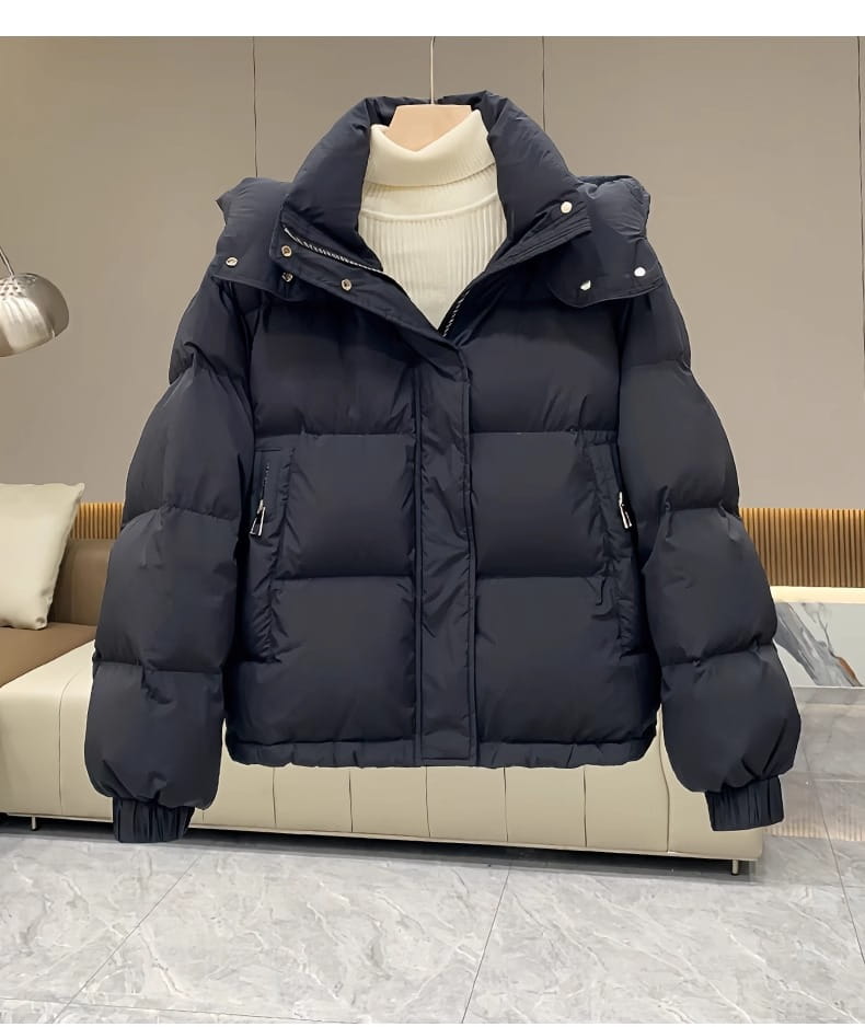 Black women puffer jacket with hood, quilted design, and silver zippers for winter wear