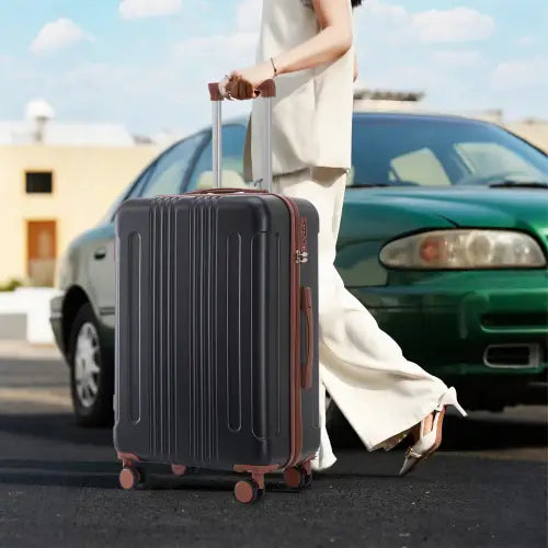 Black hard-shell abs spinner suitcase with rose gold accents, four spinner wheels, and tsa lock from a 3 piece luggage set.