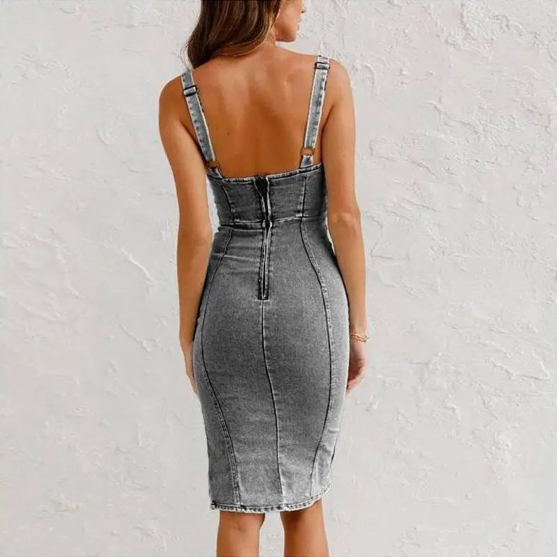 a fitted gray denim midi dress with thin straps, a square neck, side slit, and a back zipper shown from the back side