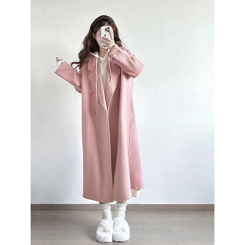 A soft pink longline wool trench coat petite featuring a cozy hood and double-breasted button closure.