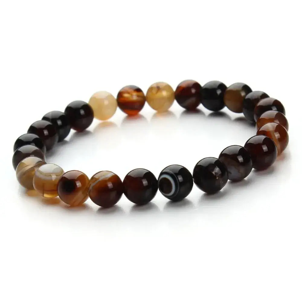 A natural polished gemstone and agate beaded bracelet composed of smooth round beads in varying shades of brown and black with natural marbled patterns.