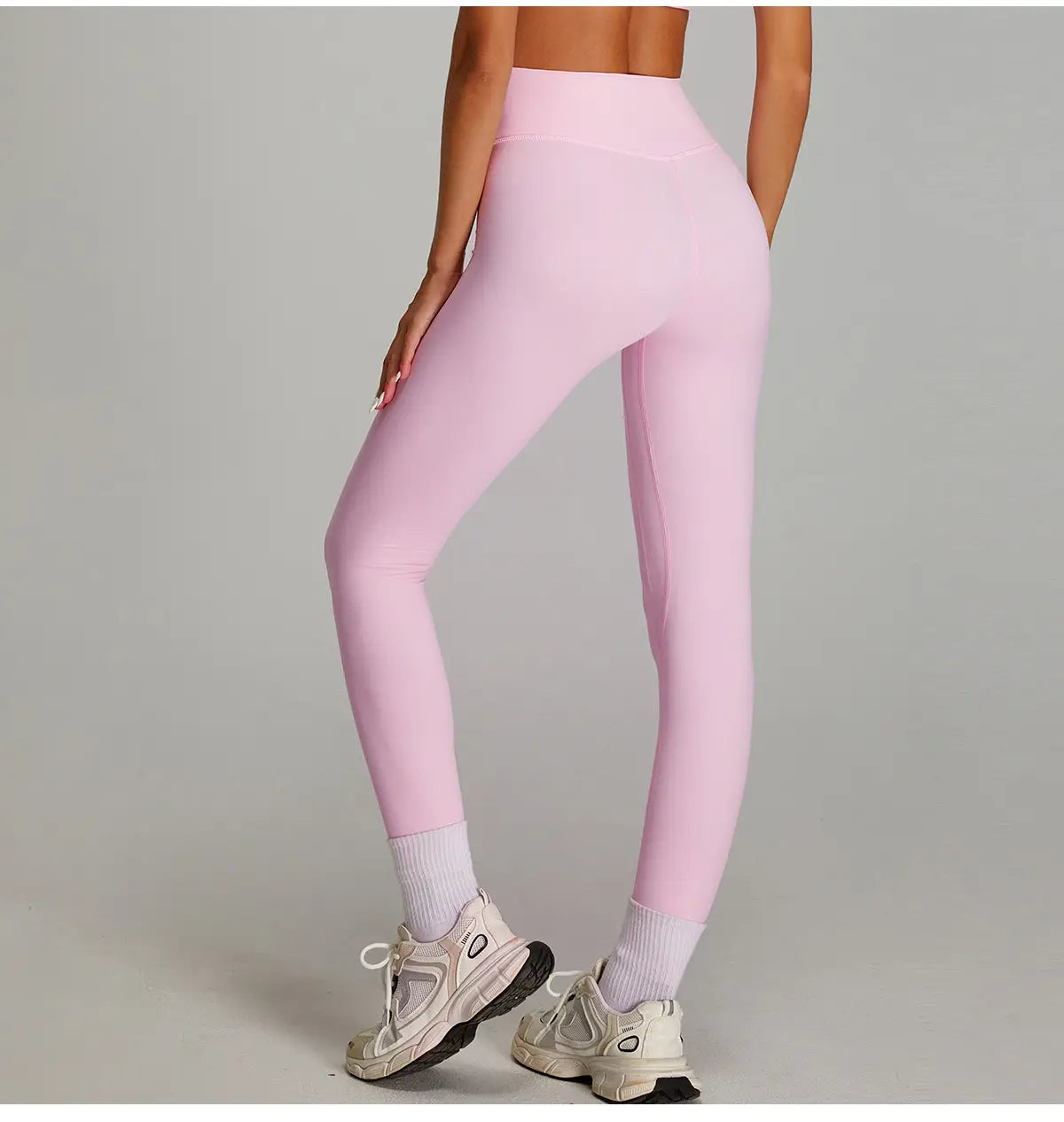 Pantalons de fitness roses à taille haute, avec un tissu lisse et extensible, conçus pour un séchage rapide et un effet nu pendant les activités sportives.