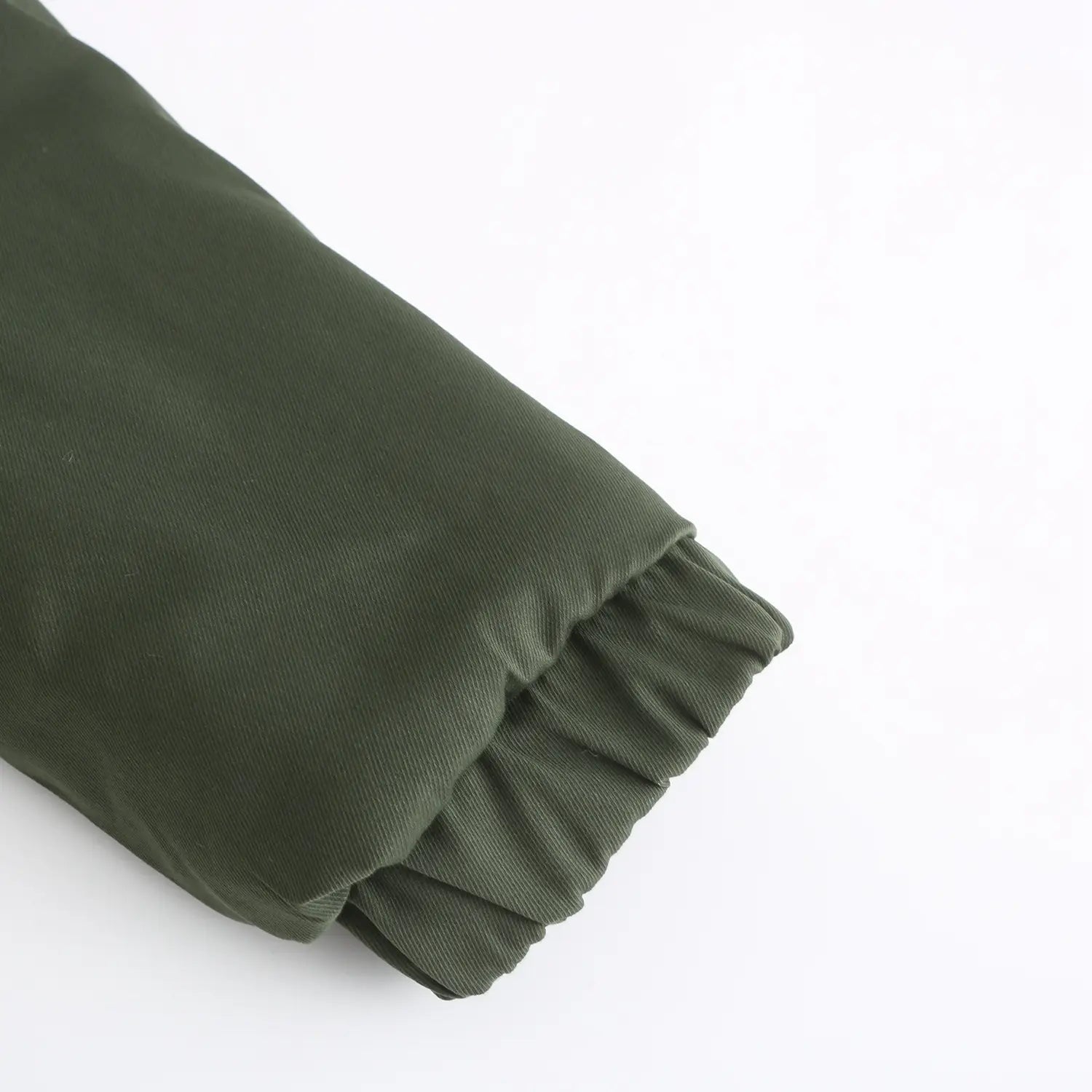 olive green corduroy sleeve with ruffled cuff detail on the reversible fur collar quilted parka.