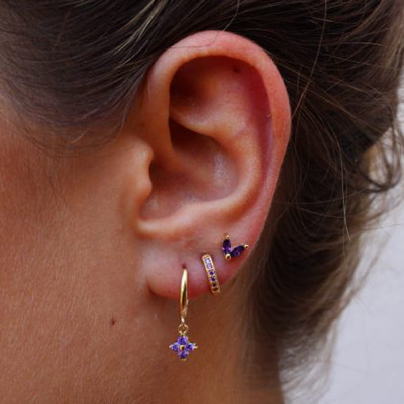 Purple butterfly-shaped stud earring with gold-tone metal and embedded gemstones from the floral and butterfly gold hoop earring set with gemstones.