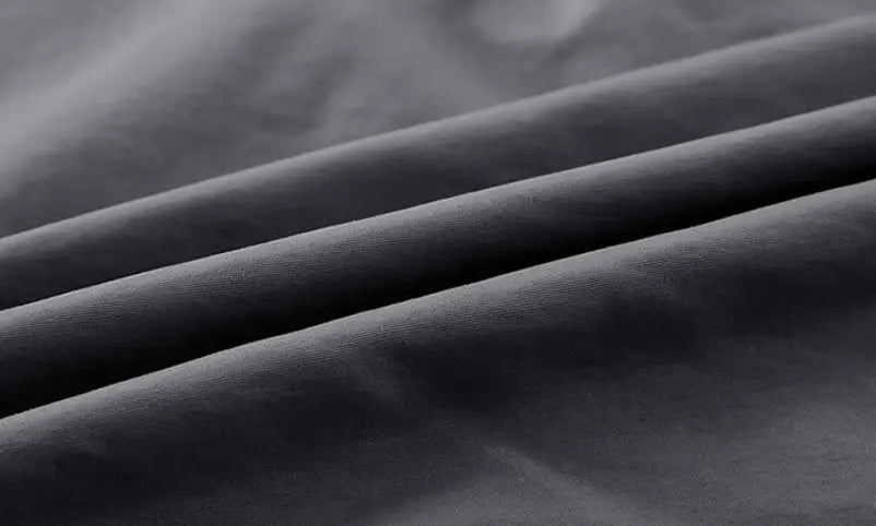 Men solid workwear shirt short sleeve in dark gray soft textured fabric with subtle folds and a smooth matte finish.