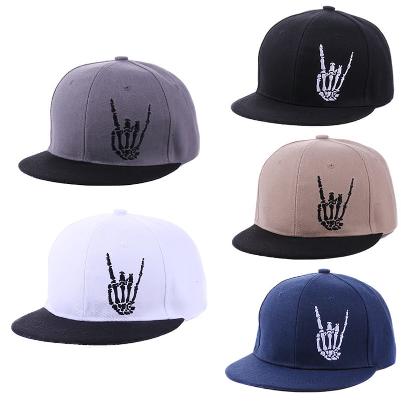 Five snapback baseball caps in gray black beige white and navy blue feature contrasting embroidered skeleton hands making the rock on gesture.
