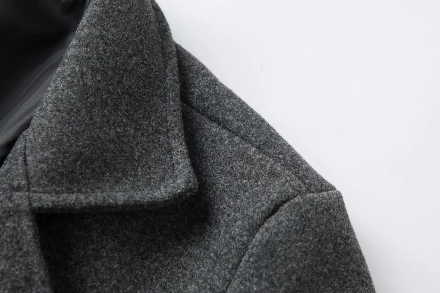 Men double breasted wool overcoat mid length coat in dark gray woolen fabric with a textured slightly heathered finish and structured collar.