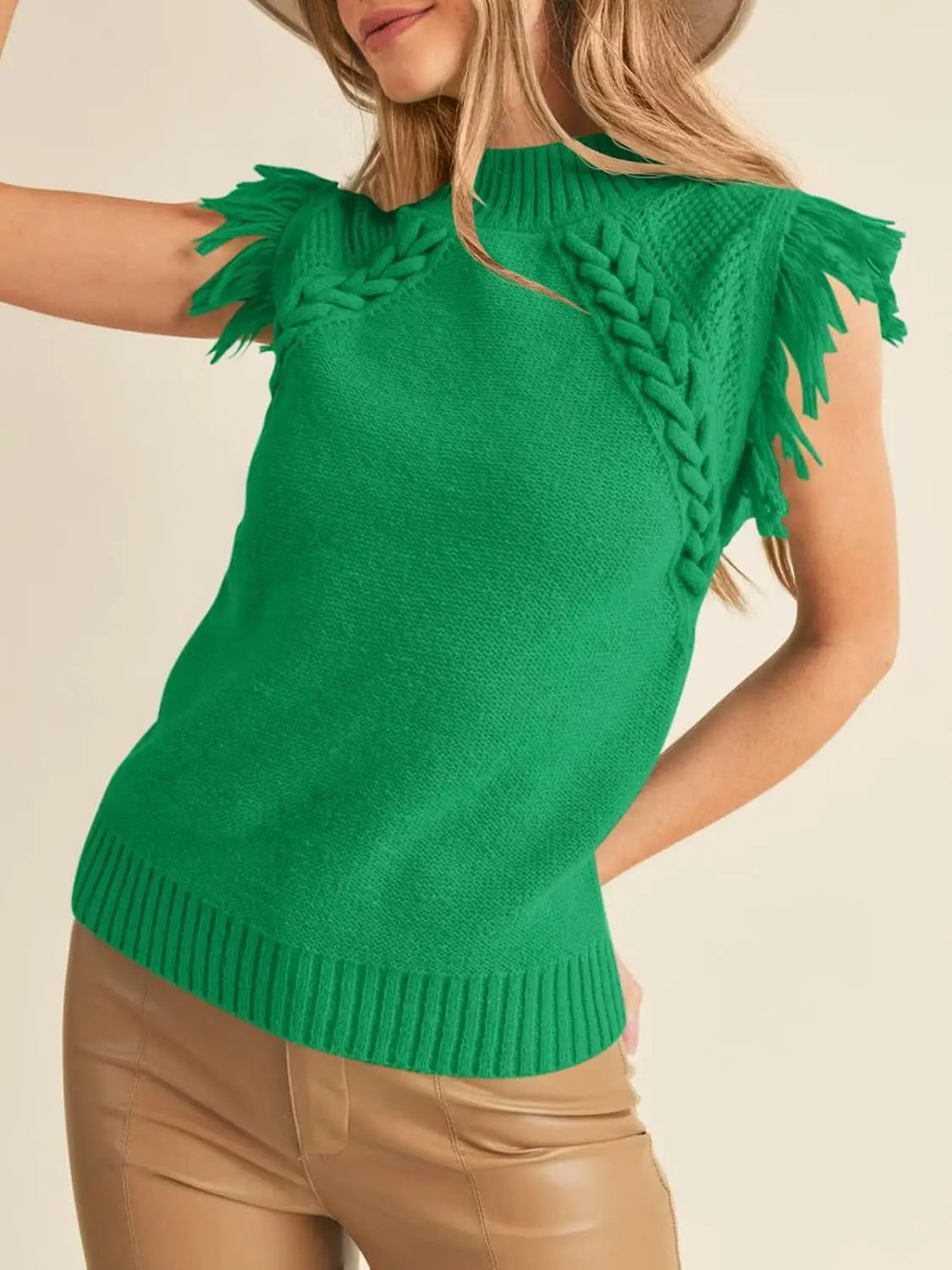 Vibrant green hand woven sleeveless knit sweater vest featuring braided fringe detailing on the shoulders.