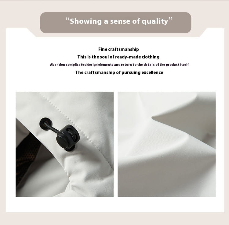 Black plastic button with sleek circular design and visible stitching on white fabric of windproof waterproof puffer jacket.
