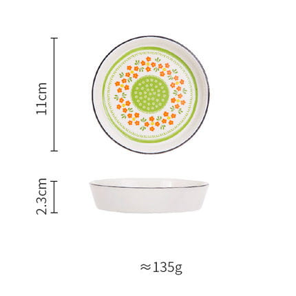 White ceramic floral bone china round serving plate with a decorative green and orange floral pattern and a black rim.