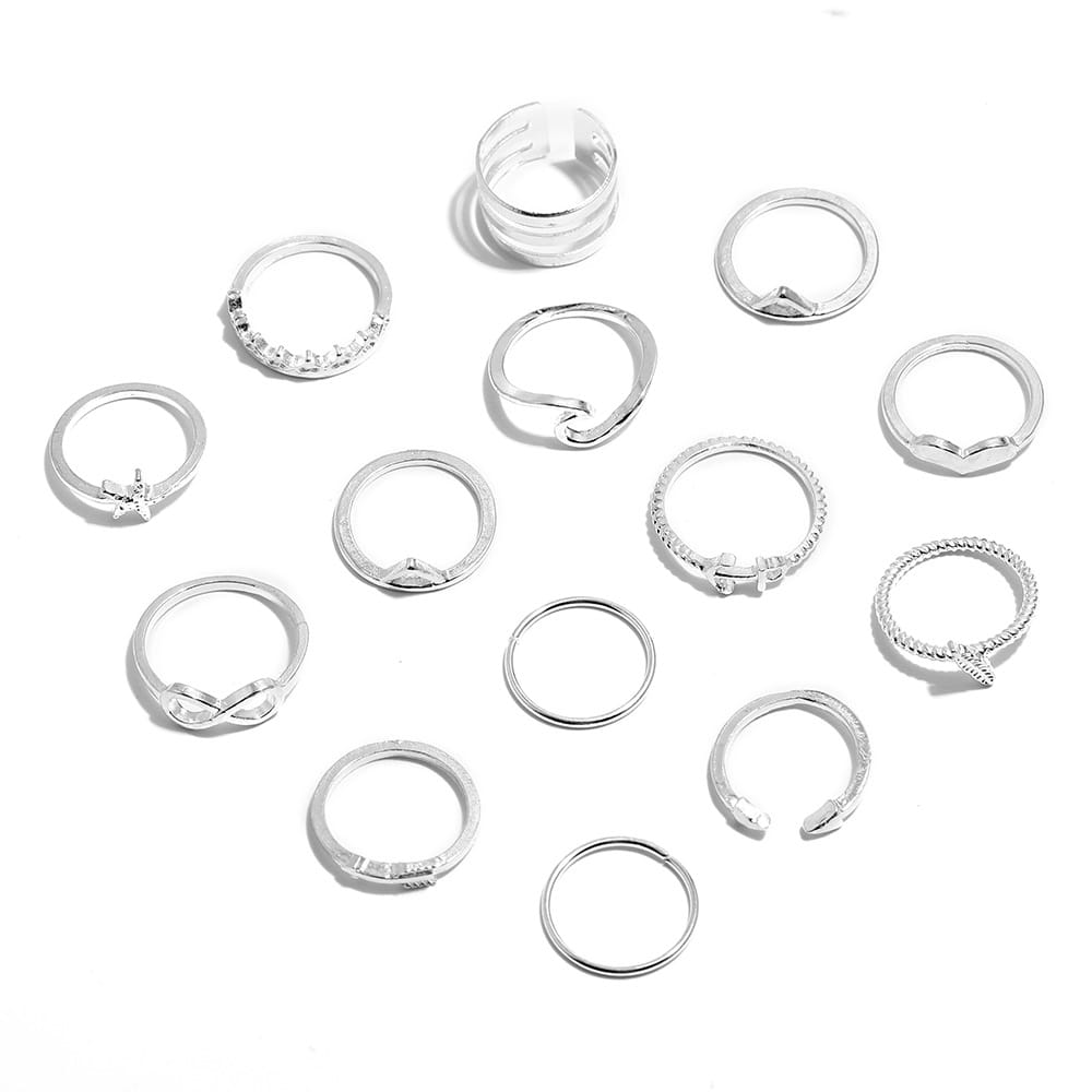 a collection of silver-toned bohemian mixed motif stackable rings featuring various designs including simple bands intricate patterns and symbolic shapes like hearts and infinity symbols