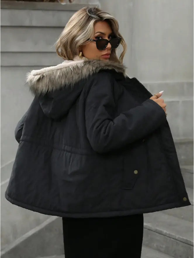 Black puffer coat with a plush light gray faux fur-lined hood shown from the back in a navy blue winter parka style.