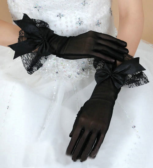 Elegant black satin evening gloves with lace trim and bow details designed for formal occasions.