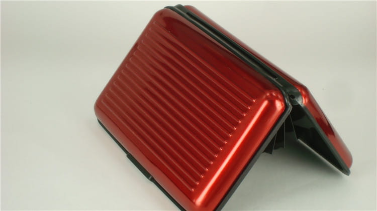 Red metallic rfid blocking aluminum alloy ribbed card holder case with vertical ridged texture and black trim.