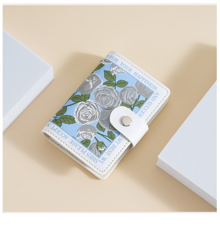 A light blue and white vintage floral PU leather multi slot card holder wallet featuring a floral design with silver roses green leaves and inspirational text along the edges.