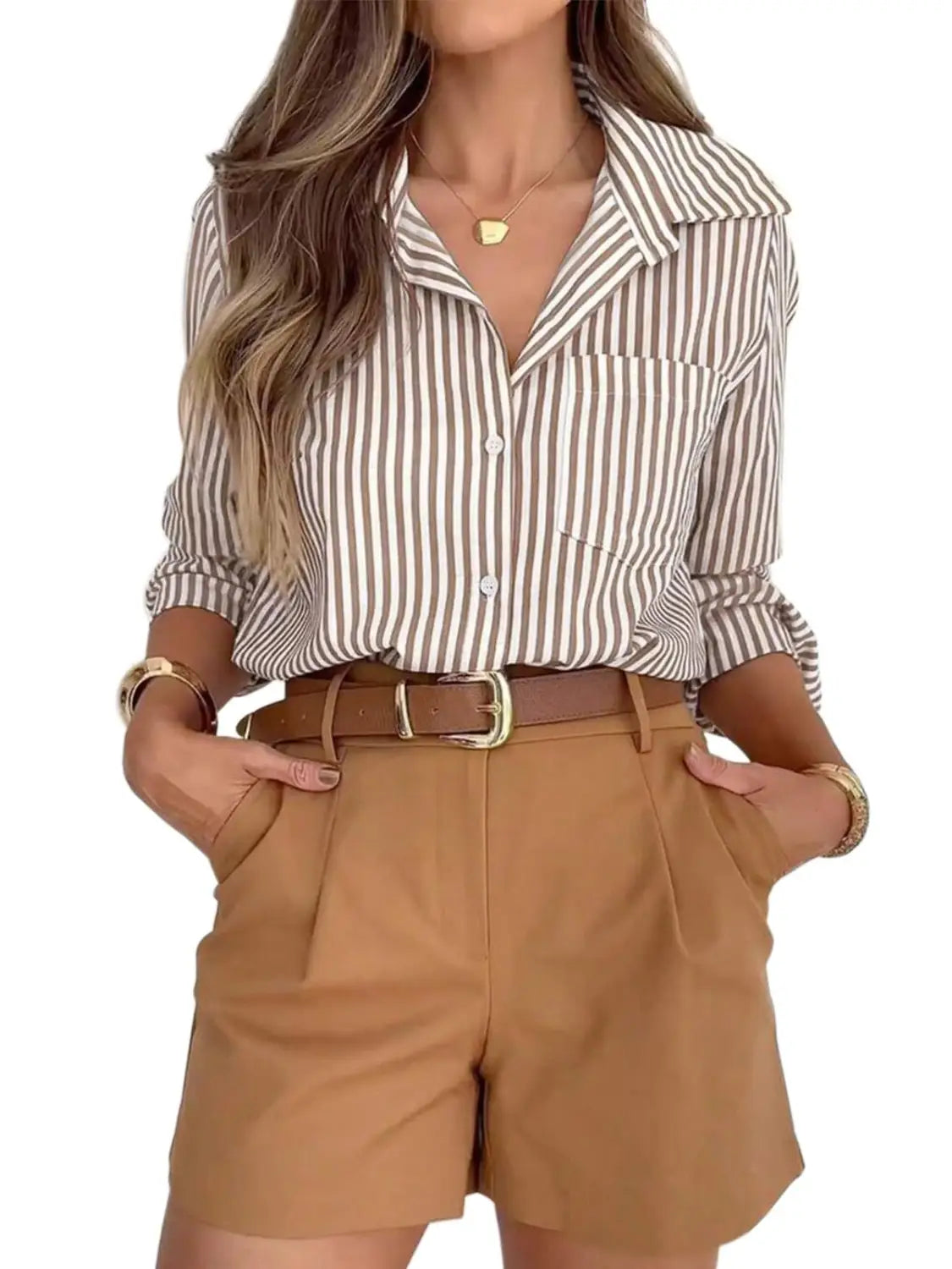 A women’s striped long sleeve button up shirt dress in beige and white with vertical stripes and rolled sleeves.