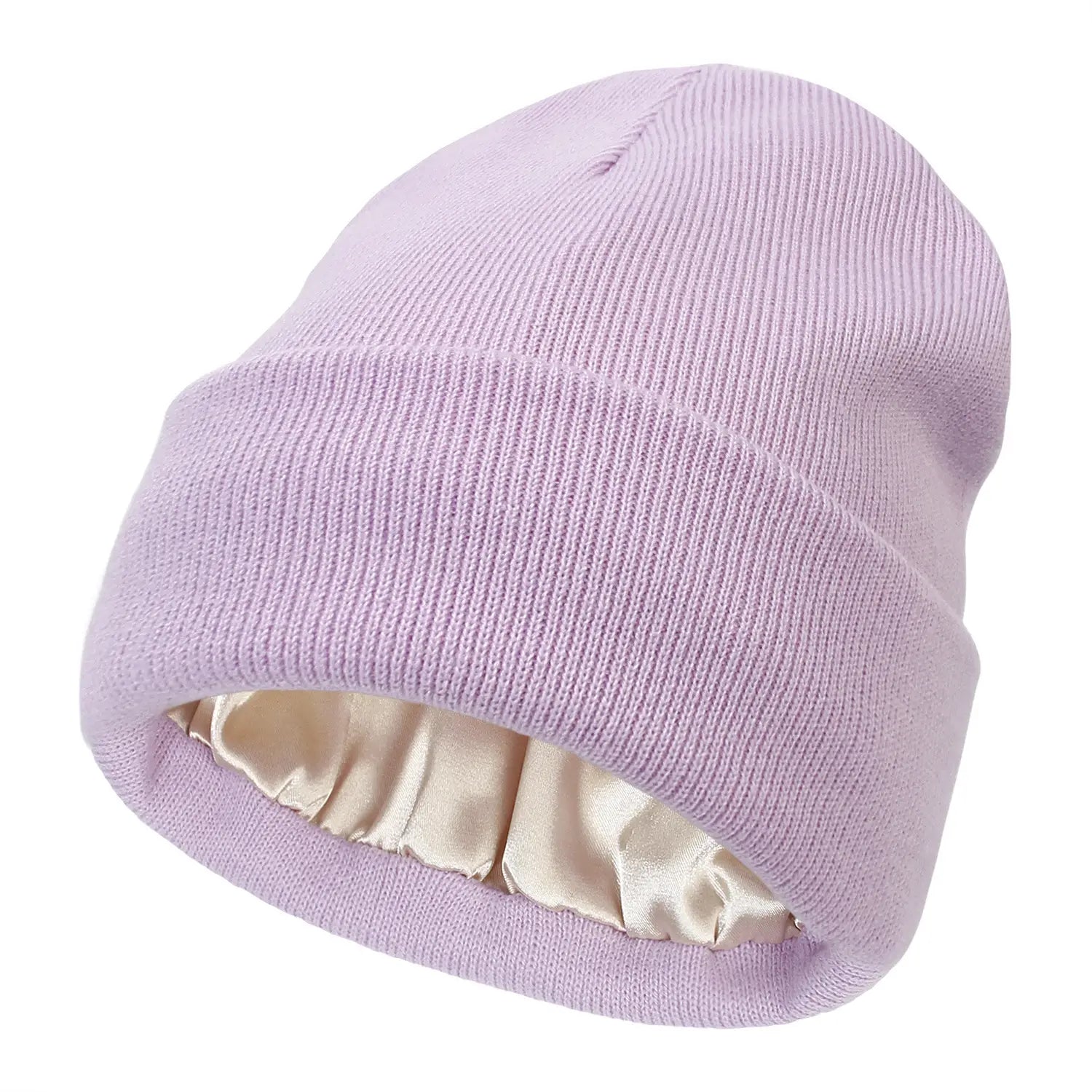 A soft lavender knit beanie with a satin-lined interior designed as a warm winter hat.