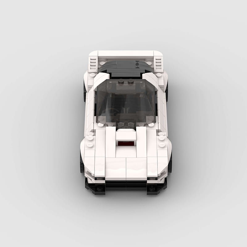 Modelo de superdeportivo con piezas de construcción LEGO Technic de Mazda RX7 FC3S en blanco y negro, que incluye una cabina transparente.