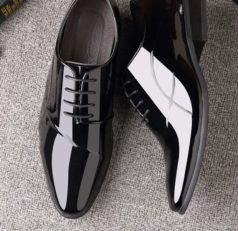 Men’s classic pointed toe leather business shoe in black patent leather with a glossy finish and white toe panel.