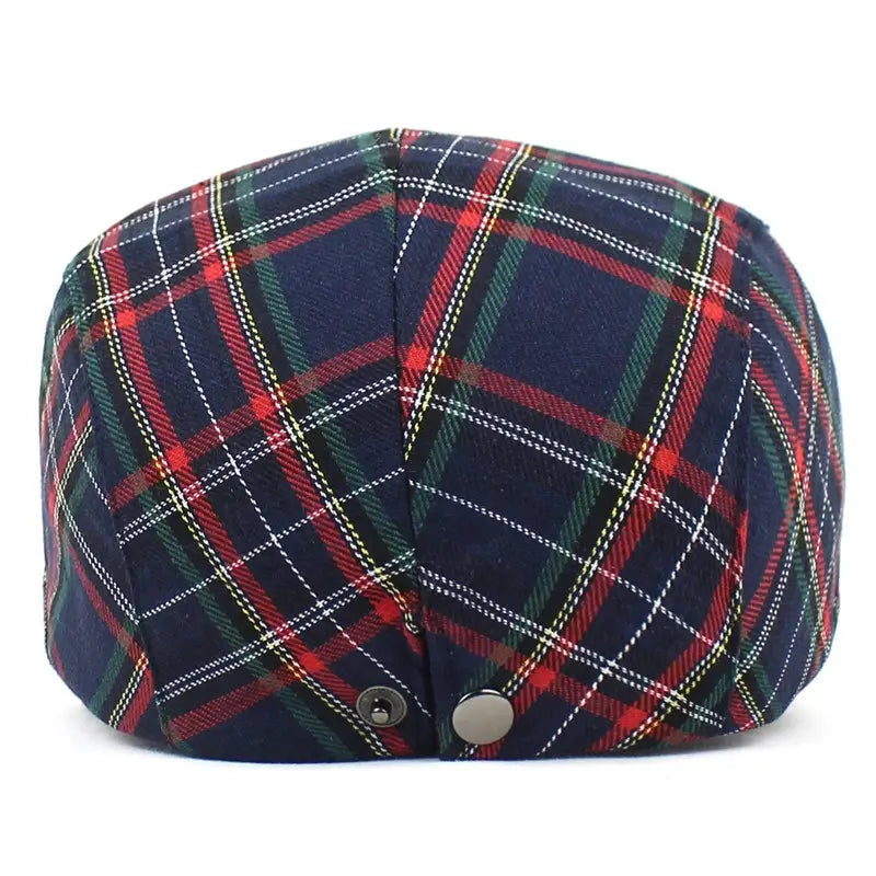 A navy blue flat plaid painter hat featuring red green and white intersecting stripes.