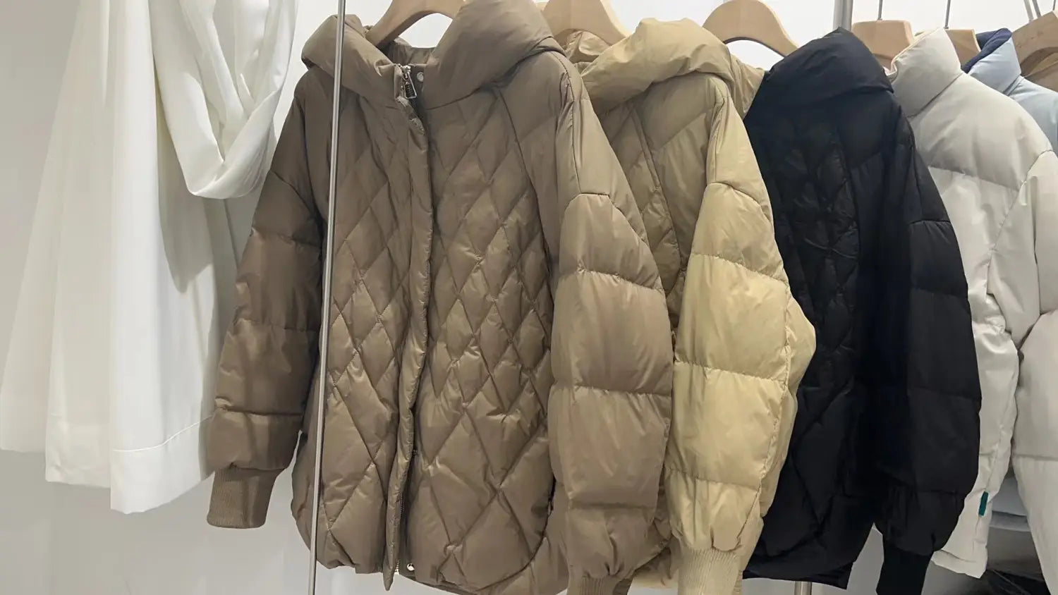 Beige quilted white duck down puffer jacket with diamond stitching hood and front zipper designed for winter use.