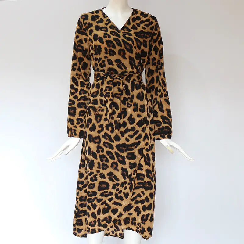 A long-sleeved chiffon wrap dress in classic leopard print with tan and black markings featuring a v neck design.