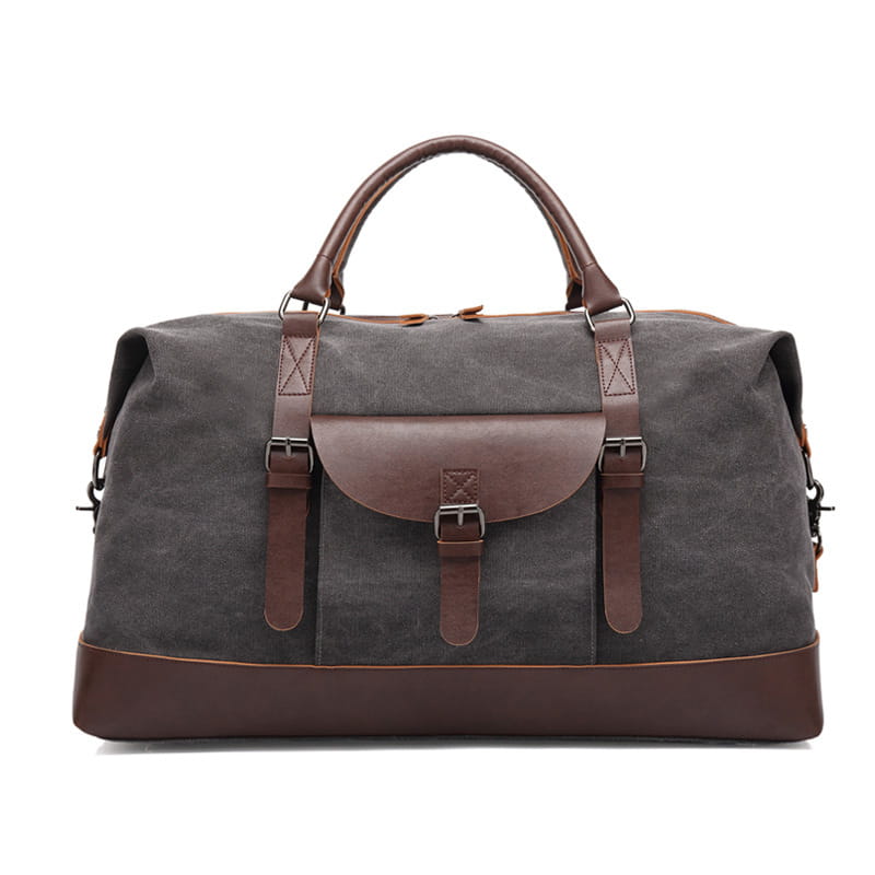 Dark gray canvas duffel bag with brown leather handles straps and trim designed as a large travel handbag