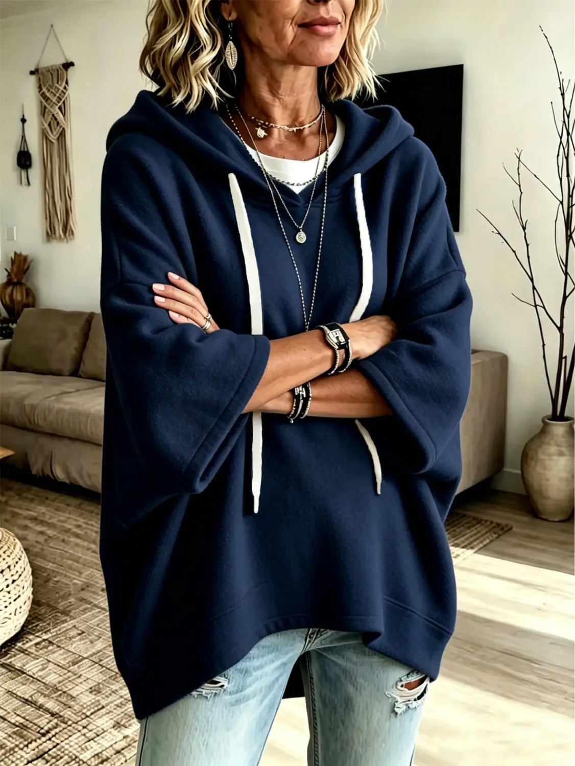 Navy blue oversized fleece hooded top with white drawstrings and three-quarter sleeves displayed from the front.