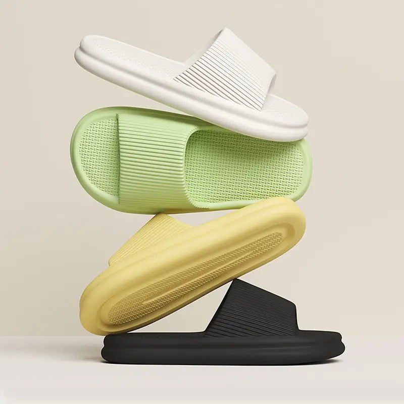 Stacked minimalist slide sandals in white mint green yellow and black with ribbed textures made of eva material designed as unisex ribbed anti slip house slippers.