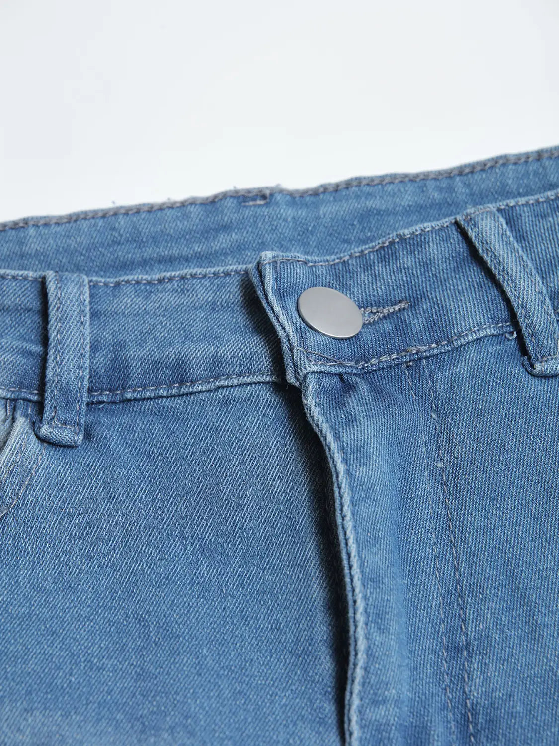 Men’s distressed slim fit stretch denim jeans in blue with a silver button and stitched seams