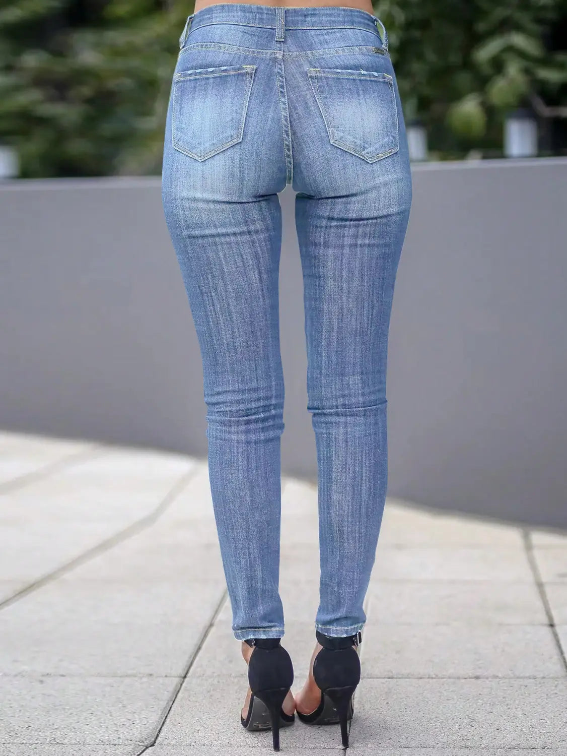 women’s high-waisted stretch skinny jeans shown from the back side featuring light-wash denim with a slim-fit cut and classic back pockets.