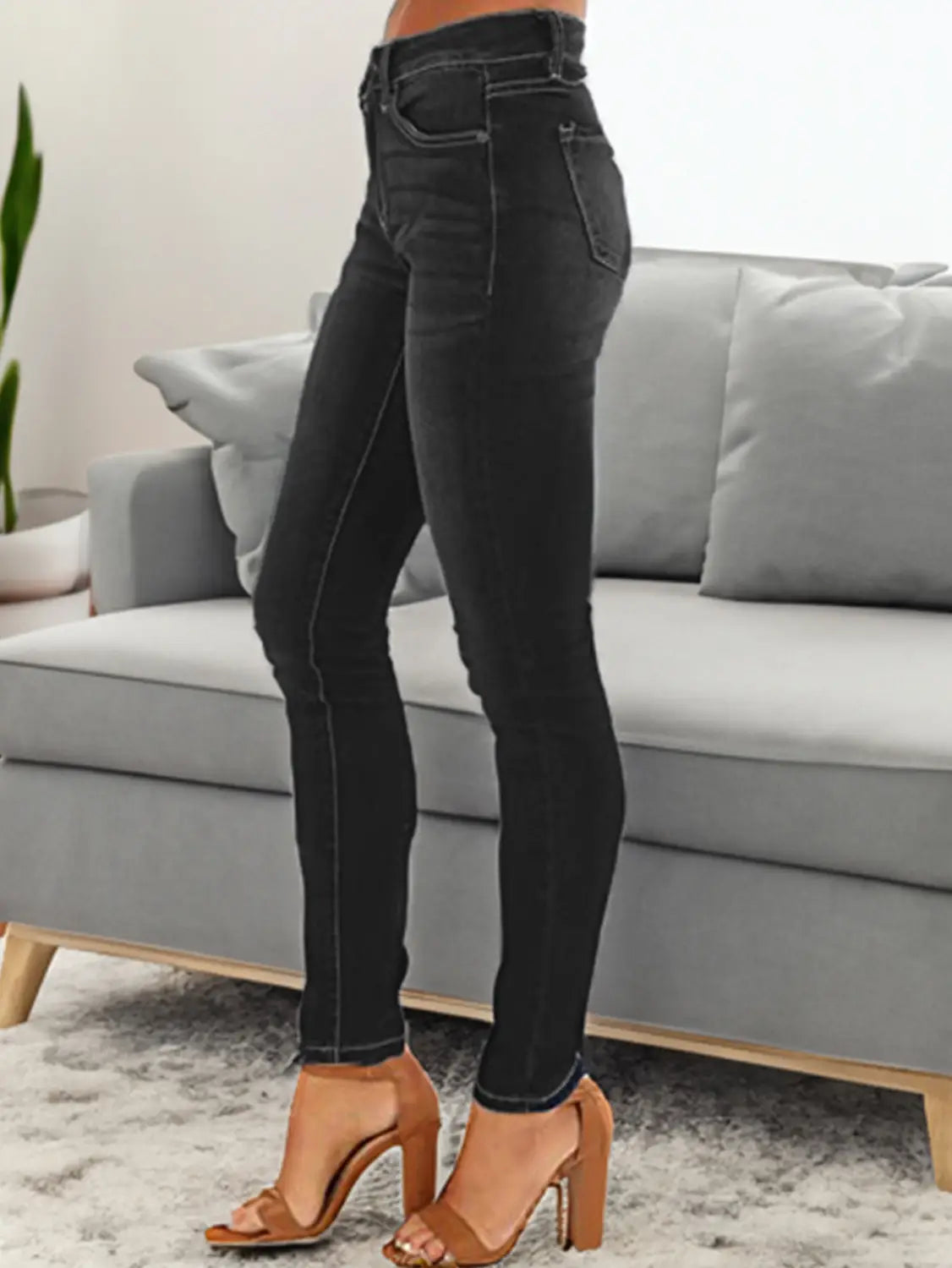 Women’s high-waisted black denim stretch skinny jeans with a slim fit and subtle whiskering details.