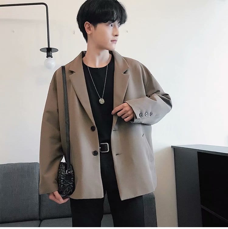Beige oversized mens loose casual thin suit jacket with relaxed fit, structured shoulders, and three-button closure.