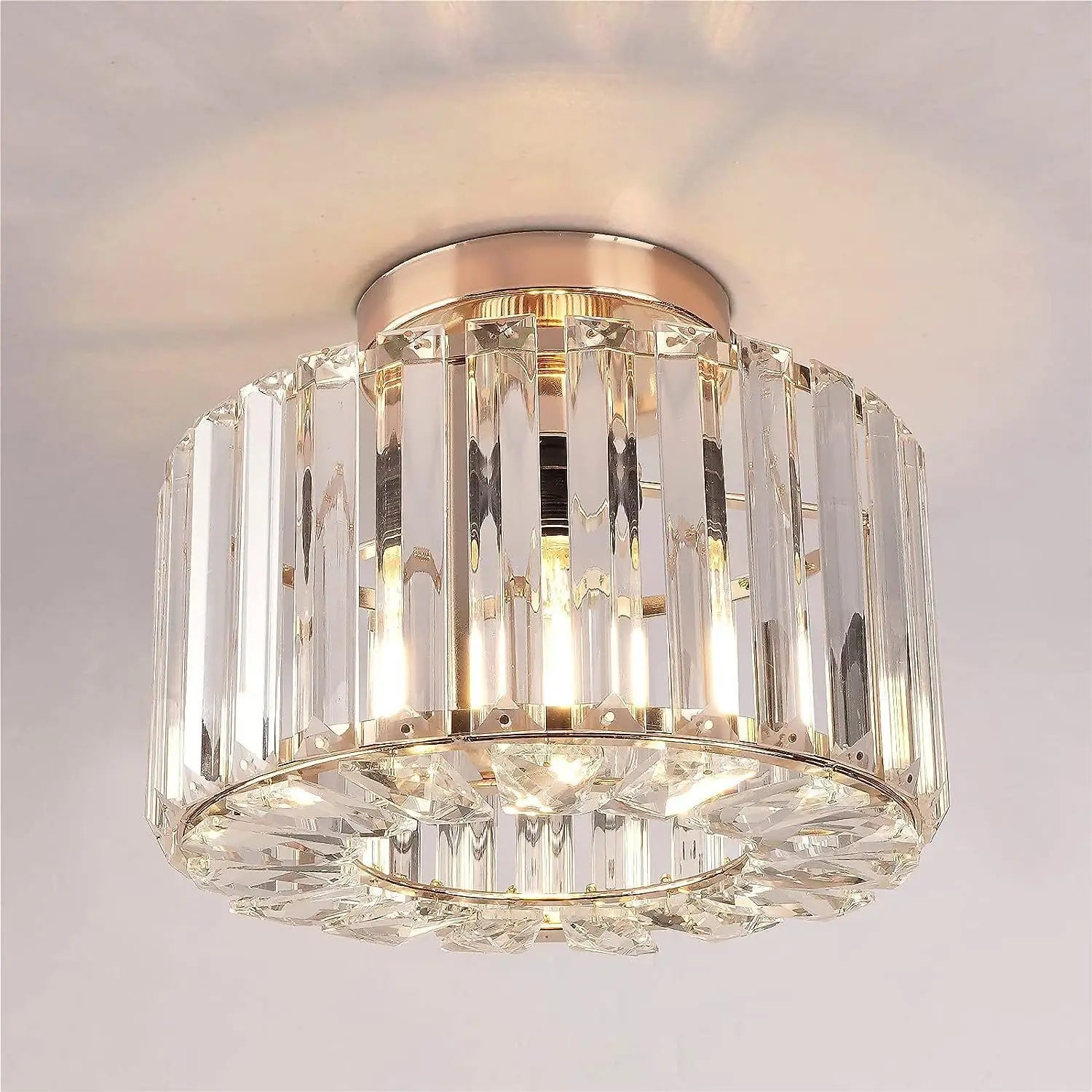 A modern crystal flush mount ceiling light chandelier with a rose gold finish and vertical faceted glass rods.