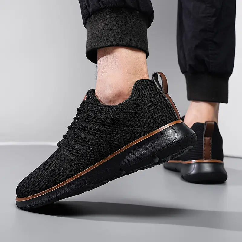 black knit mesh sneakers for men with brown leather accents and sleek modern design for casual flying woven shoes